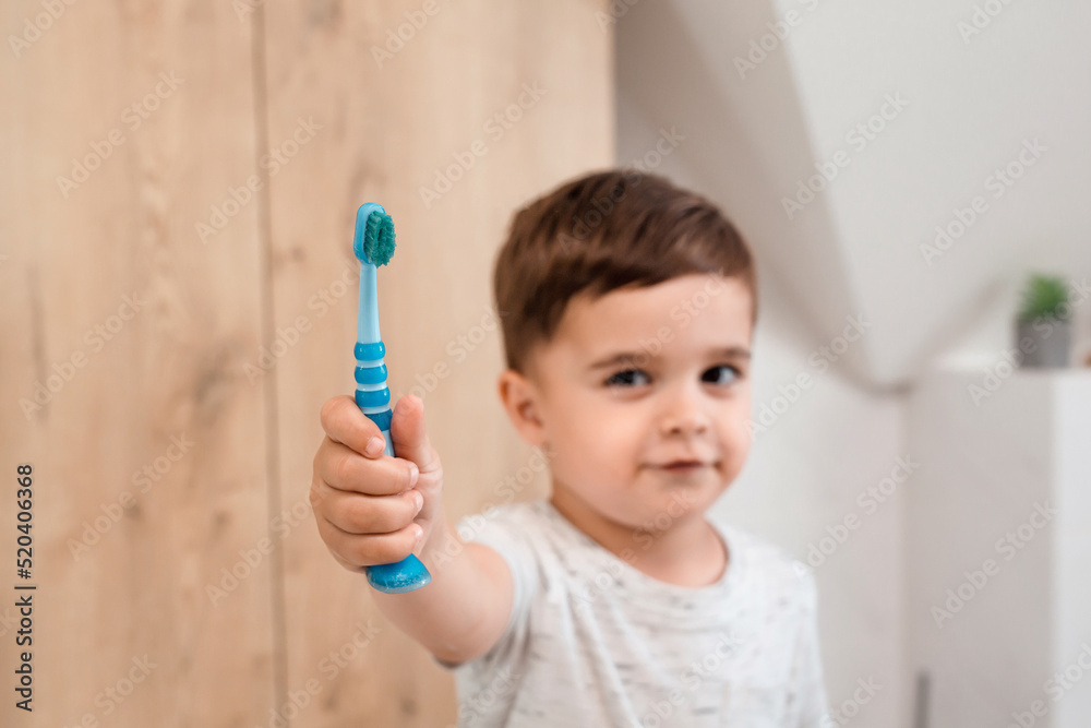 Little baby boy having fun brushing his teeth. Toddler showing his toothbrush close up Little baby boy having fun brushing his teeth. Toddler showing his toothbrush close up