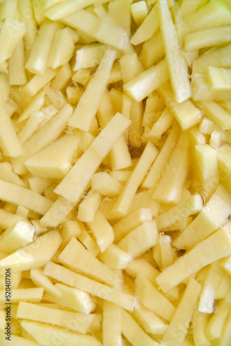 Freshly cut potatoes with straws for cooking close-up