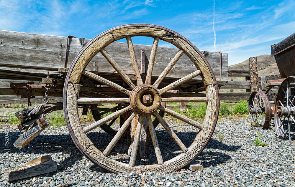 A wooden wheel on an antique horse-drawn wagon