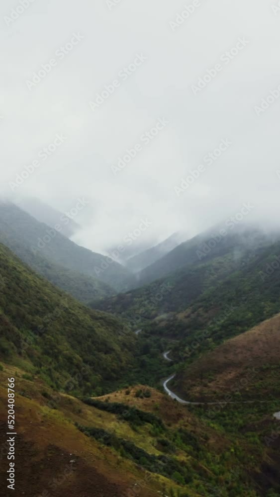 A beautiful view from a quadcopter to a mountain valley with a river in lowland A beautiful view from a quadcopter to a mountain valley with a river in lowland
