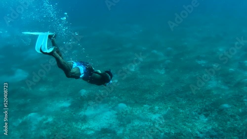 Black man snorkeling in the ocean