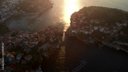 Sun shine on sea surface through old Kemere Bridge in Amasra city, Turkey during sunset photo