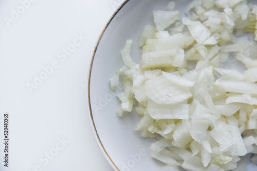 White onion cut into strips on a saucer
