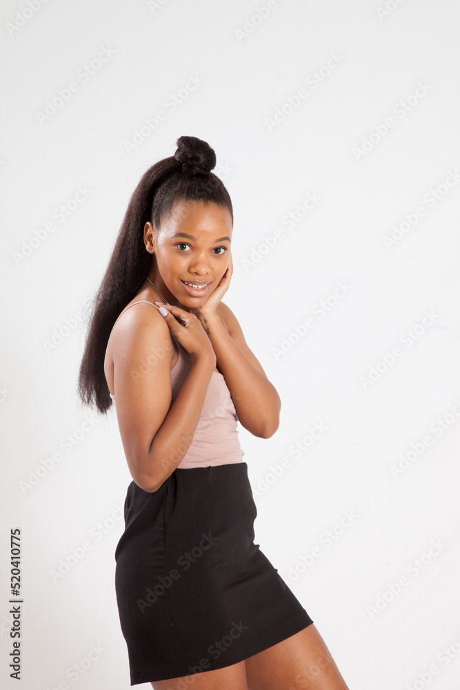 Beautiful woman with her hand to her face and a smile