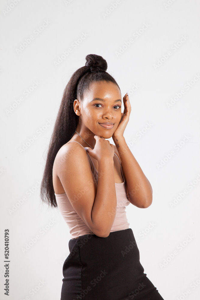 Beautiful woman with her hand to her face and a smile Beautiful woman with her hand to her face and a smile