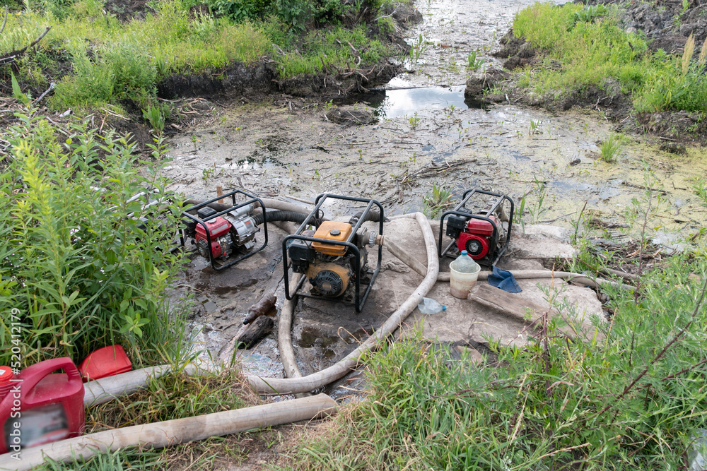 Water pumps pump water from the pond. Drainage of a reservoir, swamp ...