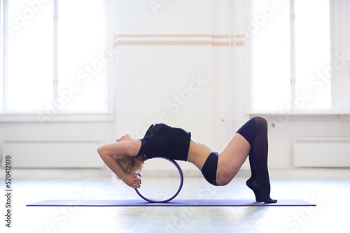 Young woman doing yoga exercise in the sports gym