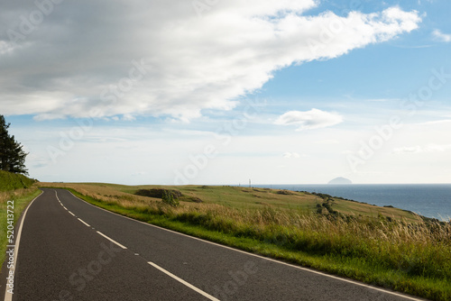 Fototapeta A pleasant road on the west coast of Scotland in Ayrshire on a sunny day with sc