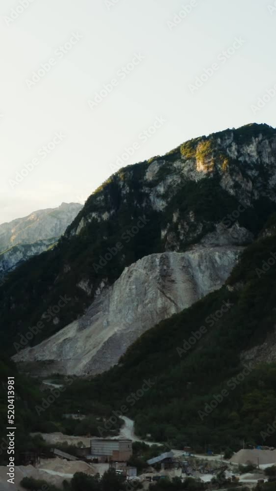 Extraction of sand in lowlands between the rocky mountains overgrown with forest Extraction of sand in lowlands between the rocky mountains overgrown with forest