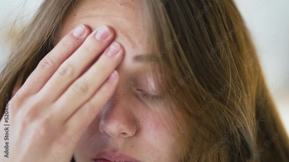 Sad girl suffers from headache. Man suffering from migraine. Emotional fatigue disorder close-up of girl face. Pain in child face. The concept of migraine and headache. Anxiety about a health problem Sad girl suffers from headache. Man suffering from migraine. Emotional fatigue disorder close-up of girl face. Pain in child face. The concept of migraine and headache. Anxiety about a health problem