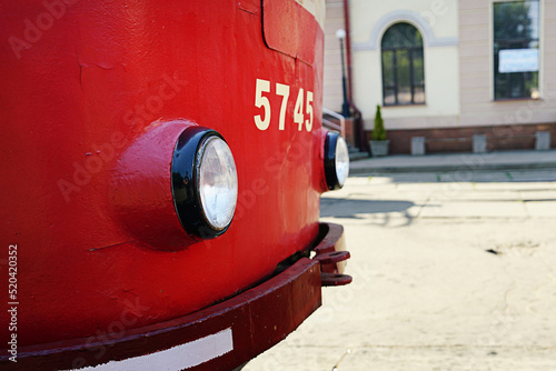 Photography Red tram part with headlight at urban street