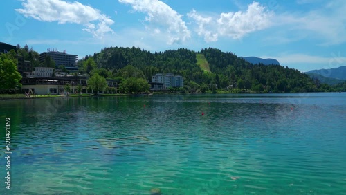 Beautiful idyllic panorama view of Lake Bled with Bled Island, Church of the Mother of God, Bled Castle and Slovenian Julian Alps on sunny summer day with blue sky cloud, Bled, Slovenia.