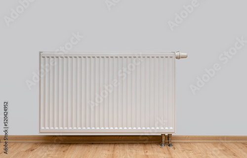 Modern white radiator with thermostat