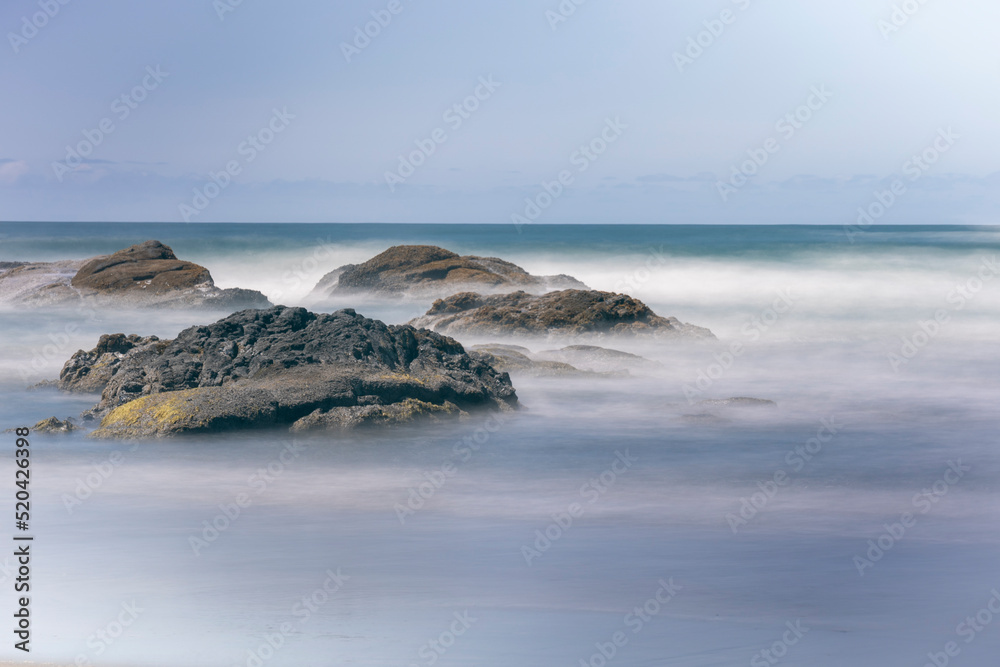The silky appearance of the beach waters from long exposure photography