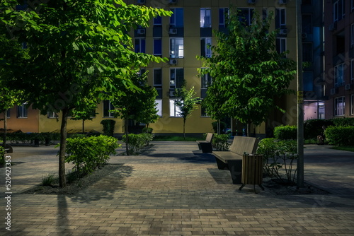Night park paths and colored houses at summer night. Night paths, benches and lanterns in a beautiful residential complex. Night summer park with lanterns and benches. Kyiv. Ukraine © decorator