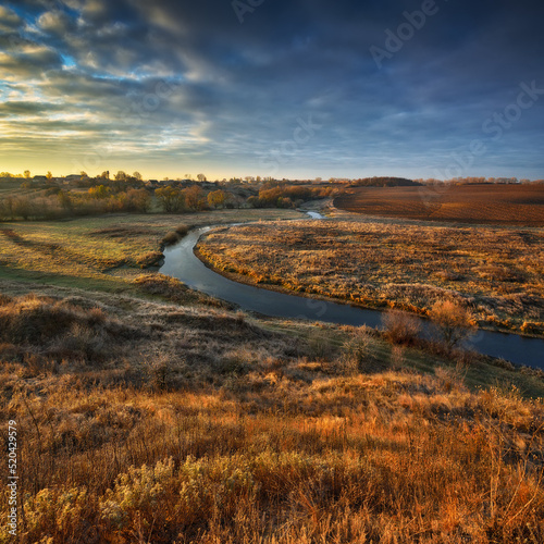 picturesque clouds over the river. autumn sunrise in the meadow