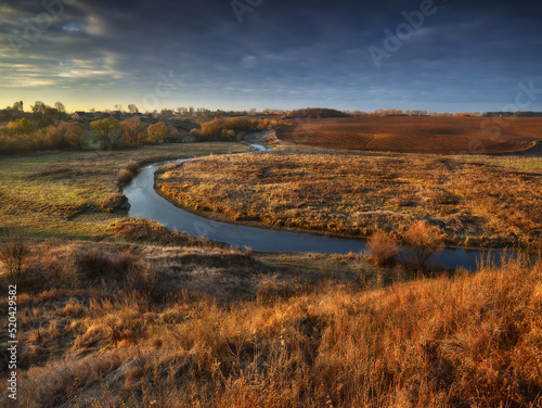 picturesque clouds over the river. autumn sunrise in the meadow