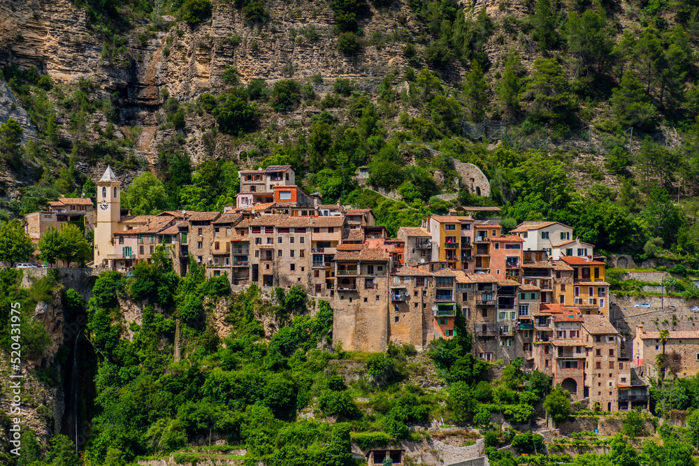 A picturesque landscape view of a medieval mountain village, Touët-sur-Var, in the Alps mountains in summer (Alpes-Maritimes, France)