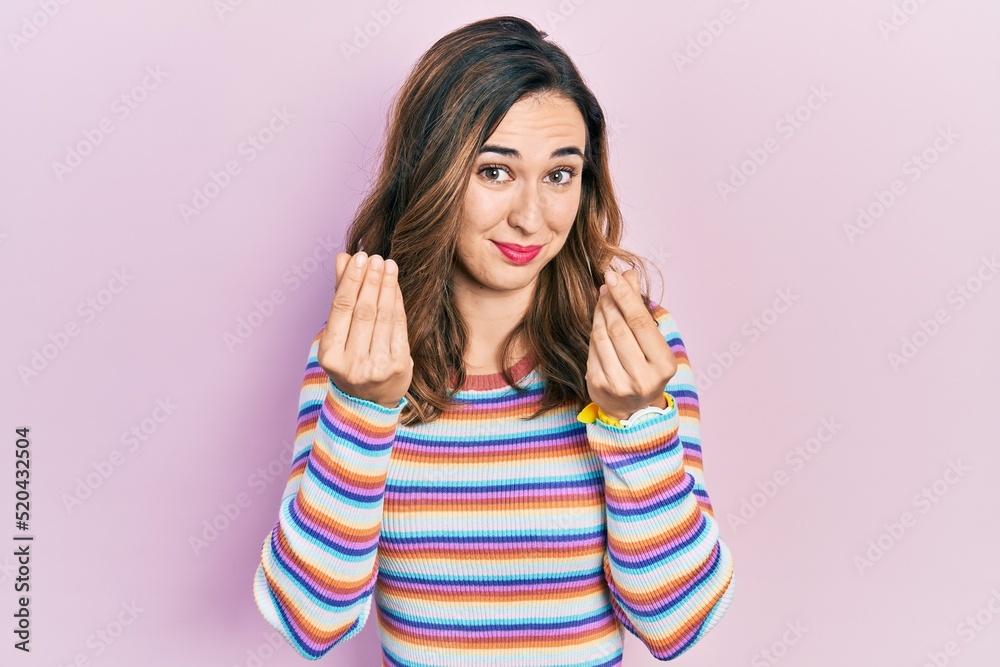 Young hispanic girl wearing casual clothes doing money gesture with hands, asking for salary payment, millionaire business Young hispanic girl wearing casual clothes doing money gesture with hands, asking for salary payment, millionaire business