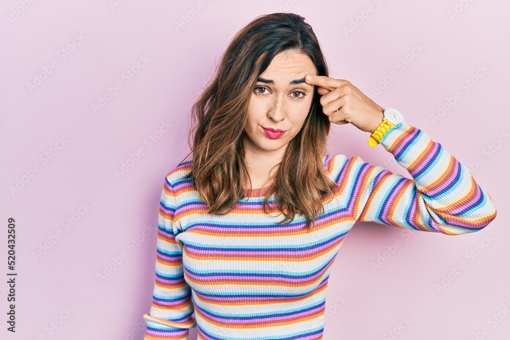 Young hispanic girl wearing casual clothes pointing unhappy to pimple on forehead, ugly infection of blackhead. acne and skin problem Young hispanic girl wearing casual clothes pointing unhappy to pimple on forehead, ugly infection of blackhead. acne and skin problem