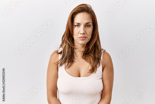 Middle age hispanic woman standing over isolated background skeptic and nervous, frowning upset because of problem. negative person. © Krakenimages.com
