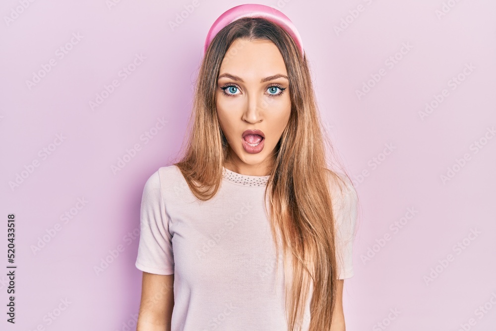 Young blonde girl wearing casual clothes afraid and shocked with surprise and amazed expression, fear and excited face. Young blonde girl wearing casual clothes afraid and shocked with surprise and amazed expression, fear and excited face.