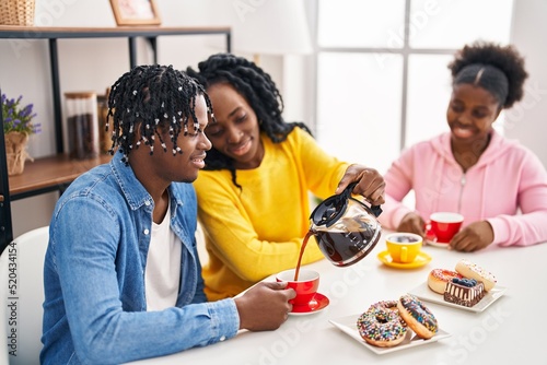 African american friends having breakfast sitting on table at home