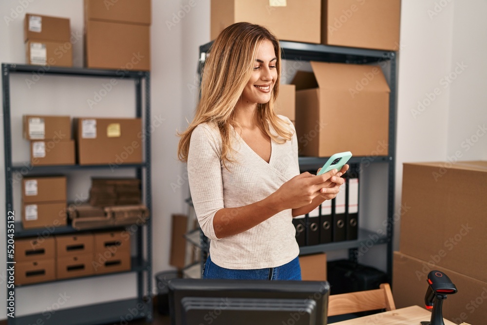 Young blonde woman ecommerce business worker using smartphone at office Young blonde woman ecommerce business worker using smartphone at office