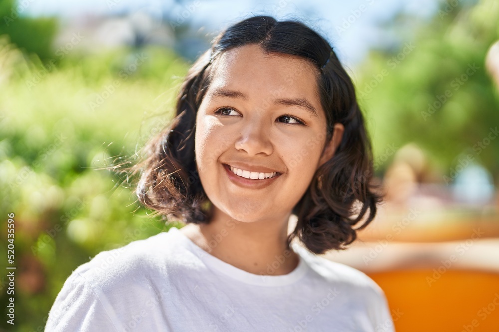 Young woman smiling confident looking to the side at park