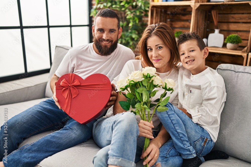 Family surprise mother with gift and flowers at home
