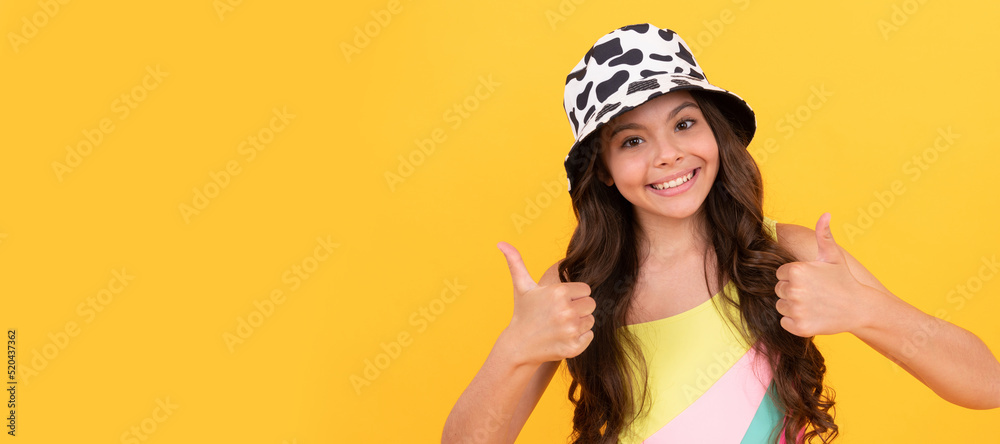 thumb up. teenager show positive emotions. child wear bucket hat. happy teen girl. Child face, horizontal poster, teenager girl isolated portrait, banner with copy space. thumb up. teenager show positive emotions. child wear bucket hat. happy teen girl. Child face, horizontal poster, teenager girl isolated portrait, banner with copy space.