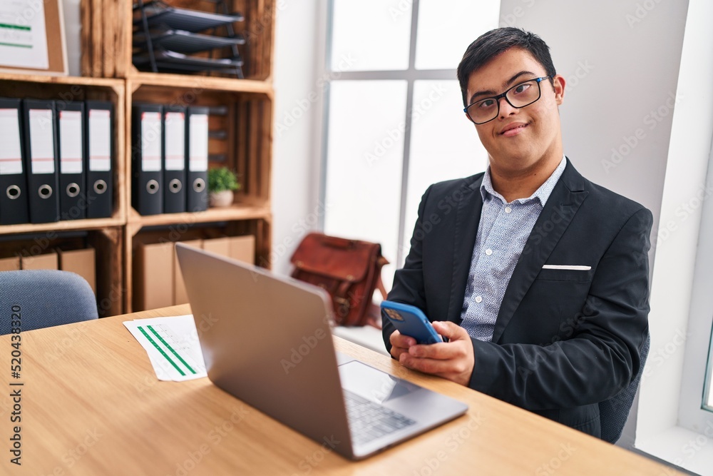 Down syndrome man business worker using smartphone at office Down syndrome man business worker using smartphone at office