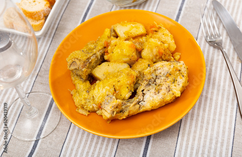 Delicious baked chicken pieces with side dish of home-style stew potatoes served for dinner..