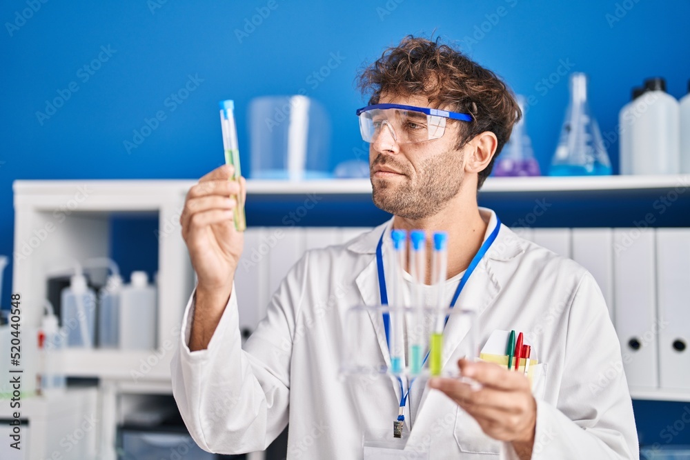 Young man scientist holding test tubes at laboratory Young man scientist holding test tubes at laboratory