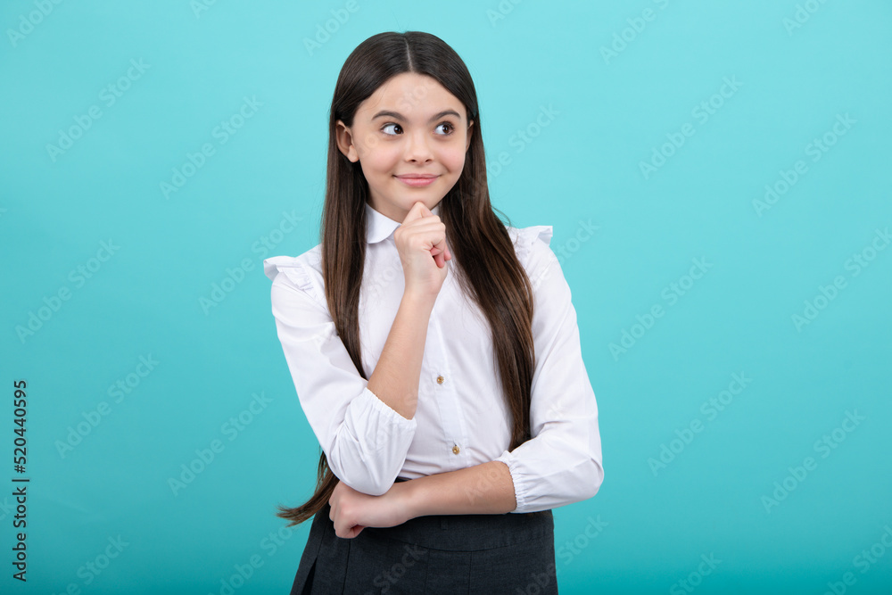 Beautiful teenager child over isolated yellow background with hand on chin thinking about question, thoughtful face. Doubt concept. Beautiful teenager child over isolated yellow background with hand on chin thinking about question, thoughtful face. Doubt concept.