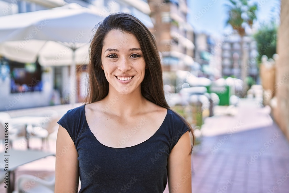 Young hispanic girl smiling happy standing at the city. Young hispanic girl smiling happy standing at the city.