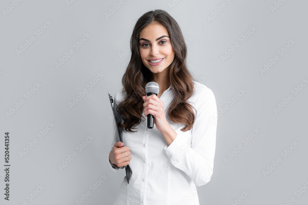 Young business woman talking with mic. Woman talking with microphone. Communication and information concept. Young business woman talking with mic. Woman talking with microphone. Communication and information concept.