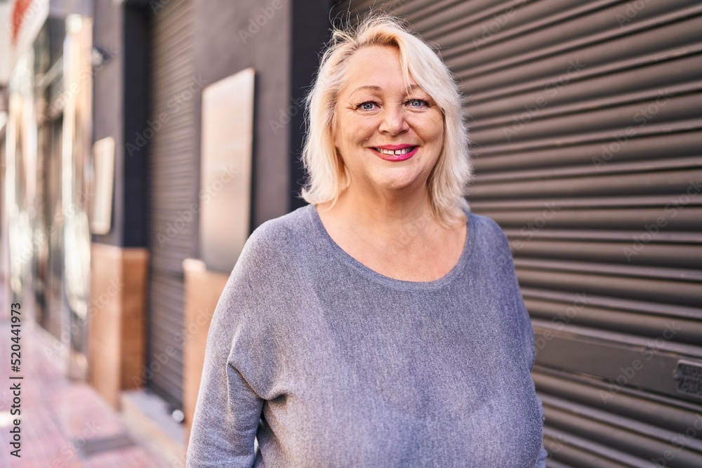 Middle age blonde woman smiling confident standing at street Middle age blonde woman smiling confident standing at street
