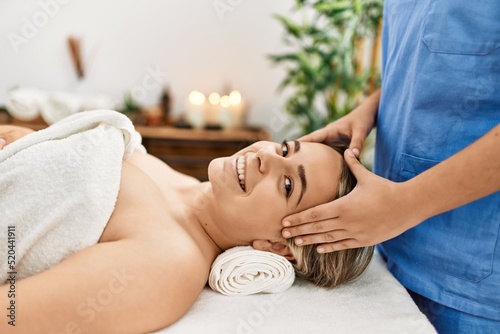 Woman couple smiling confident having facial massage at beauty center photo