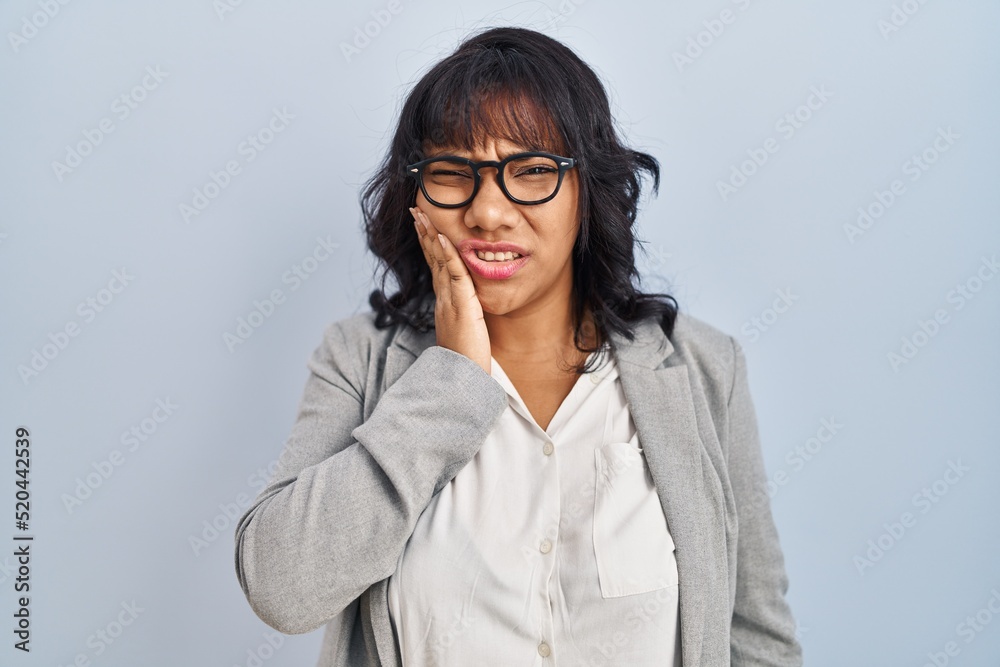 Hispanic woman standing over isolated background touching mouth with hand with painful expression because of toothache or dental illness on teeth. dentist Hispanic woman standing over isolated background touching mouth with hand with painful expression because of toothache or dental illness on teeth. dentist