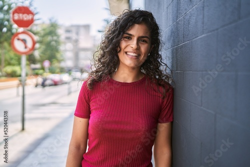 Young latin woman smiling confident standing at street