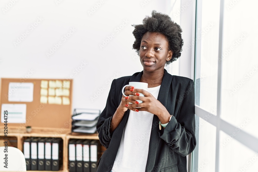 Young african american woman smiling confident drinking coffee at office Young african american woman smiling confident drinking coffee at office
