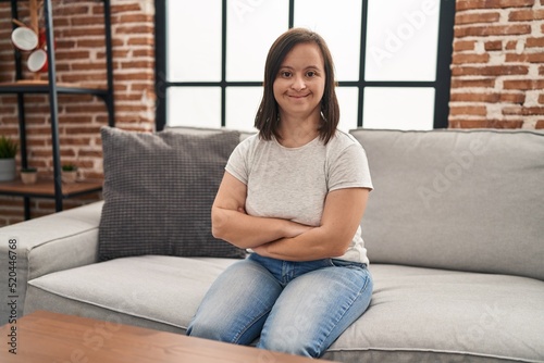 Down syndrome woman sitting on the sofa with arms crossed gesture at home Free Download Down syndrome woman sitting on the sofa with arms crossed gesture at home - GFXLoad