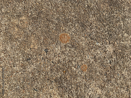 Concrete with tiny pebbles and rust stains