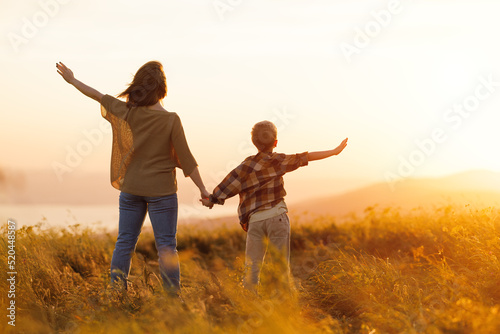 happy family mother and son in nature at sunset