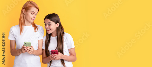 Mother and daughter child banner, copy space, isolated background. shopping app. modern communication technology. mother and daughter typing and texting. © Olena