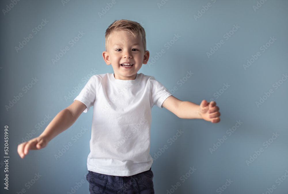 Happy smiling little boy jumping in studio setting. Happy smiling little boy jumping in studio setting.
