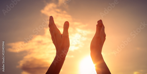 Person's hands up to the sunlight. Feelings of hope and happiness 