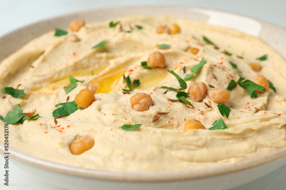 Tasty hummus with garnish in bowl, closeup