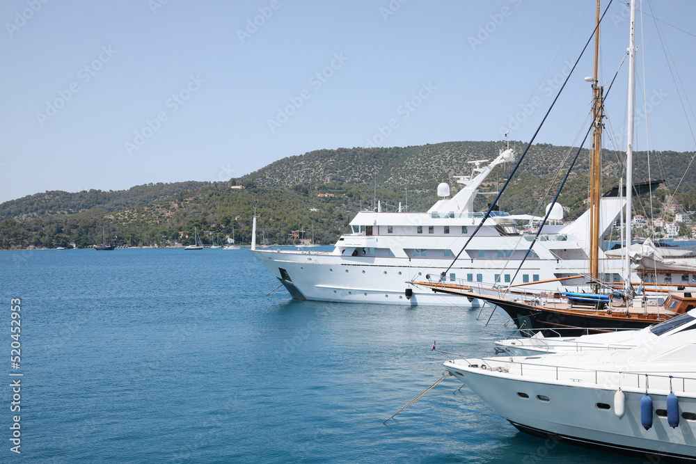 Beautiful view of different boats in sea near shore on sunny day